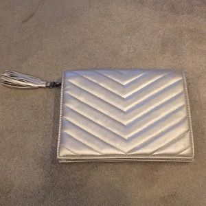 Neiman Marcus blush metallic clutch with tassel